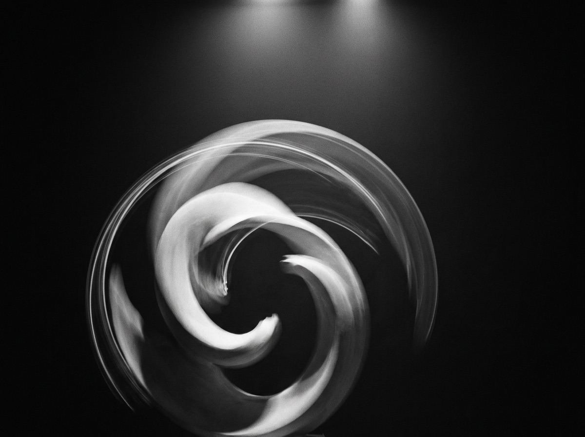 Monochrome long-exposure of a rotating sculptural form